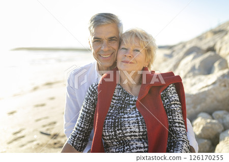 Happy senior couple smiling and enjoying a day at the beach 126170255