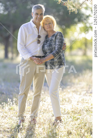 Happy senior couple holding hands and embracing in nature 126170280