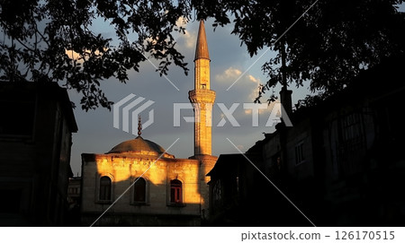 Golden Hour Sunset View of Mosque Minaret and Dome Urban Architecture Cityscape 126170515