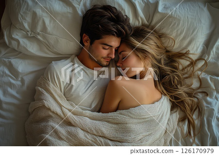 Close up of a young loving heterosexual couple sweet sleeping embracing each other. In a tender embrace, the couple sleeps soundly, their love radiating through their peaceful expressions. 126170979