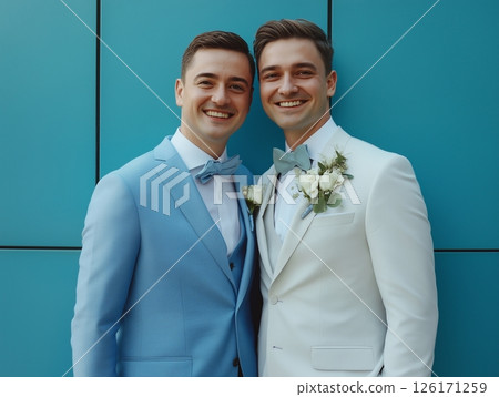Two grooms on their wedding day, standing together and smiling, celebrating love and commitment. 126171259