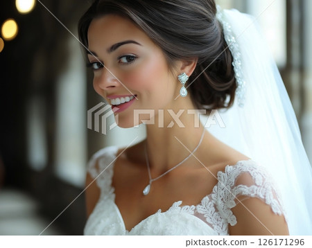 Portrait of brunette bride in white dress and veil, elegant and radiant bridal look. 126171296