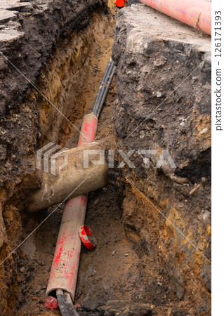 Repair of sewage heating systems or electricity. A trench has been dug in the ground. Repair of sewage heating systems or electricity. A trench has been dug in the ground. 126171393