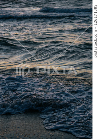 Ocean with waves, sunset sky is orange. water is choppy and waves are crashing on shore. Ocean with waves, sunset sky is orange. water is choppy and waves are crashing on shore. 126171395