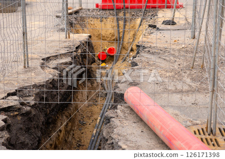Repair of sewage heating systems or electricity. A trench has been dug in the ground. Repair of sewage heating systems or electricity. A trench has been dug in the ground. 126171398