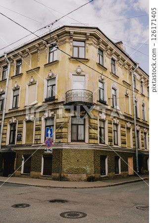 old corner house of yellow-green color. historical architecture, house with a balcony. 126171405