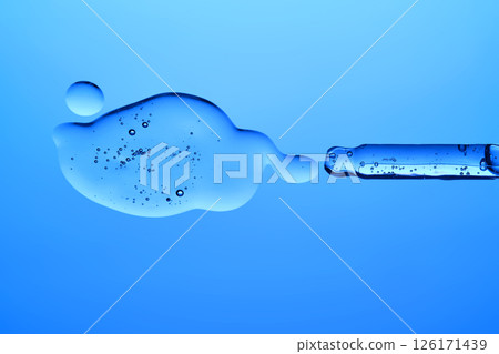A dropper with a transparent serum texture on a blue background. 126171439
