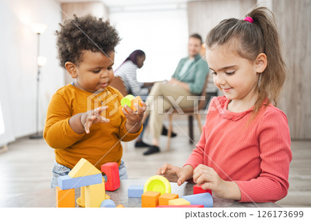 Multiracial family enjoying playtime at home with colorful blocks 126173699