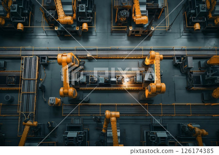 Top down view of a modern factory with robotic arms assembling a product on a production line 126174385
