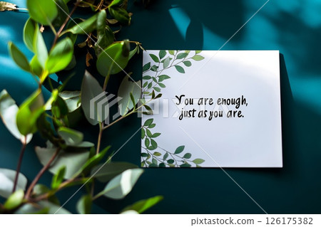 Elegant greeting card with a reassuring message you are enough, just as you are, set against a rich teal backdrop 126175382