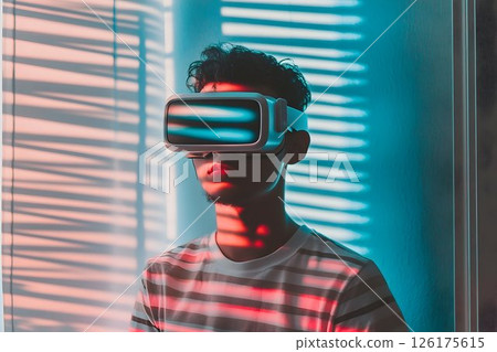 Young man immersed in virtual reality experience with advanced VR headset 126175615