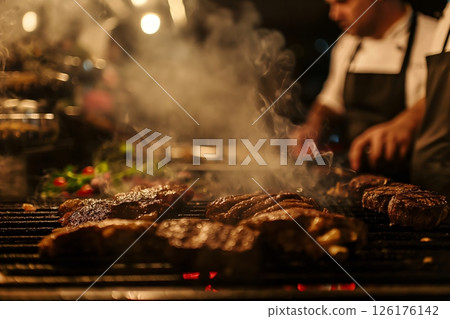 Close up of argentinian steaks grilling on a barbecue grill, with a cook in the background and smoke rising from the hot coals Close up of argentinian steaks grilling on a barbecue grill, with a cook in the background and smoke rising from the hot coals 126176142