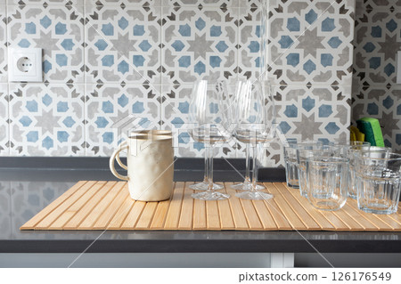 Kitchen counter with washed glassware and ceramic mug 126176549
