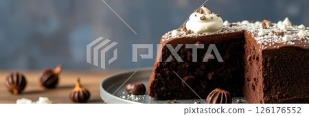 Delicious chocolate cake served on a plate with decorative toppings in a cozy setting 126176552
