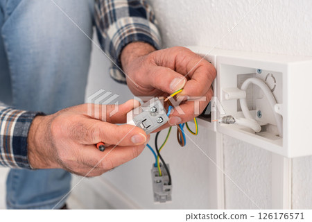 Electrician at work on a residential electrical system. Electricity. 126176571