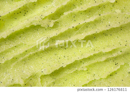 Green body exfoliating scrub texture. Abstract kiwi or apple background of sugar scrub for skin body care. Skincare exfoliating scrubber. Green body exfoliating scrub texture. Abstract kiwi or apple background of sugar scrub for skin body care. Skincare exfoliating scrubber. 126176811