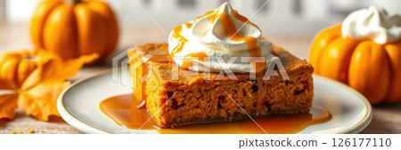 Delicious pumpkin dessert served with whipped cream and caramel sauce, perfect for autumn gatherings and celebrations 126177110