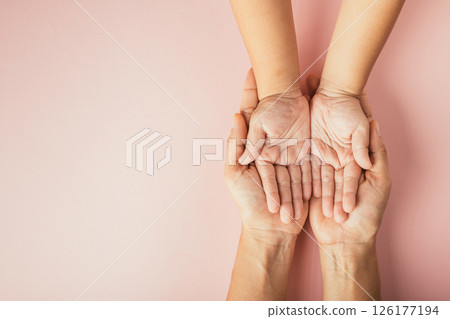 Family day concept, Top view of parents and kid holding empty hands isolated on a color background. Celebrating togetherness and support. Family day concept, Top view of parents and kid holding empty hands isolated on a color background. Celebrating togetherness and support. 126177194