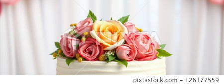 Beautifully decorated cake with fresh roses on top at a celebration event 126177559