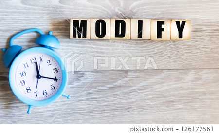 Modify the concept of the word on wooden blocks, next to the clock 126177561