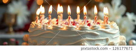 Celebrating a birthday with a beautifully decorated cake featuring lit candles and festive decorations 126177671