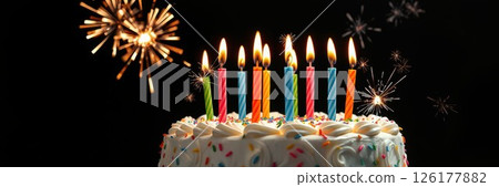 Colorful birthday cake with candles and fireworks creates a joyful celebration atmosphere 126177882