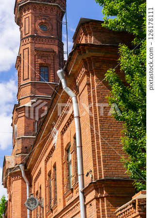 Old Fire station. Arch and window with metal decorations. 126178111