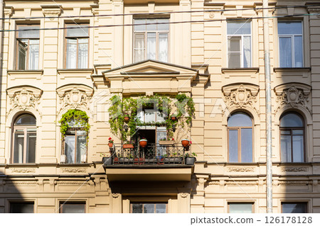 Minimalist architecture building facade of old historic house exterior. Decorative ornamental design elements of classic European style apartment building front view Minimalist architecture building facade of old historic house exterior. Decorative ornamental design elements of classic European style apartment building front view 126178128