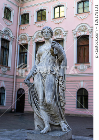 Greek classical ancient statue. Old roof statue of a Renaissance Era woman philosopher and poet. Greek classical ancient statue. Old roof statue of a Renaissance Era woman philosopher and poet. 126178131