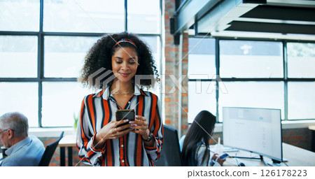 Creative agency, businesswoman and smile with smartphone for notification, online news or contact in office. Coworking, female person or journalist with chat on tech, blog application or social media 126178223