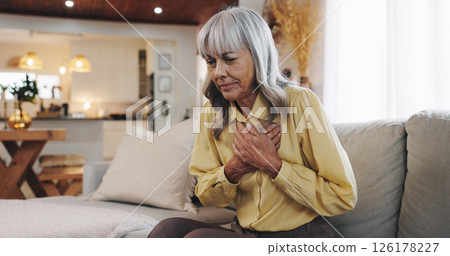 Heart attack, chest pain and sick with old woman on sofa for hypertension, medical emergency and stress. Anxiety, health risk and cardiac arrest with senior person at home for high blood pressure 126178227