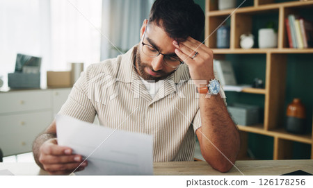 Remote work, man and headache in home with paperwork, mistake and finance crisis in startup. Entrepreneur, mental health and doubt in living room with invoice, document and upset for business debt Remote work, man and headache in home with paperwork, mistake and finance crisis in startup. Entrepreneur, mental health and doubt in living room with invoice, document and upset for business debt 126178256