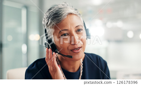 Mature, happy woman or consultant talking with headset at call center for online communication. Female person, agent or employee with mic or technology for virtual assistance or customer service 126178396