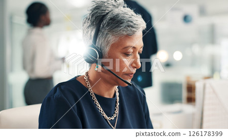 Mature woman, agent and talking with headset at call center for online communication or customer service. Female person, consultant or employee with mic or technology for virtual assistance at office 126178399
