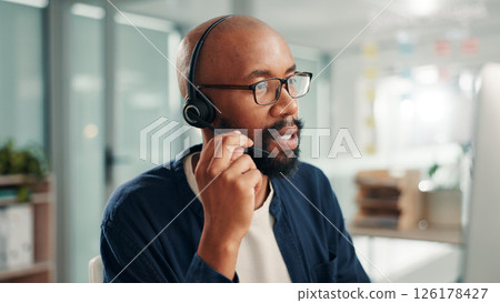 Business, call center and black man in office talking for contact us, crm service and customer support. Glasses, professional consultant and person with headset for communication, advice and feedback Business, call center and black man in office talking for contact us, crm service and customer support. Glasses, professional consultant and person with headset for communication, advice and feedback 126178427