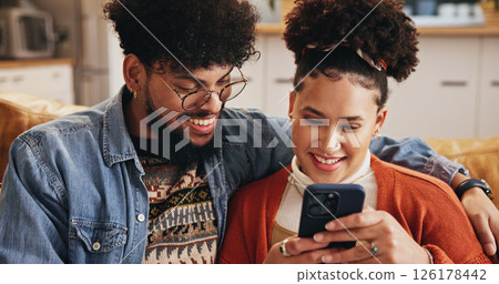 Mobile, happy couple and embrace in home to relax with social media post, video and financial news. Phone, man and woman in living room with app for online banking, check account and credit score 126178442