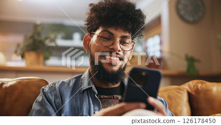 Man, happy and relax with phone on sofa for social media scroll, mobile chat or reading online news. Smile, person or smartphone in home for streaming subscription, app download or browse dating site 126178450