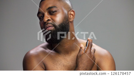 Hygiene, black man and portrait with perfume in studio for grooming routine, fresh fragrance and odor prevention. Mockup space, person and spray cologne on gray background for self care or body scent Hygiene, black man and portrait with perfume in studio for grooming routine, fresh fragrance and odor prevention. Mockup space, person and spray cologne on gray background for self care or body scent 126178457