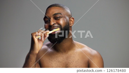 Toothbrush, smile and black man in studio for hygiene, fresh breath and mockup in morning. Portrait, wellness and person brushing teeth for dental care, cleaning or grooming on grey background space Toothbrush, smile and black man in studio for hygiene, fresh breath and mockup in morning. Portrait, wellness and person brushing teeth for dental care, cleaning or grooming on grey background space 126178480