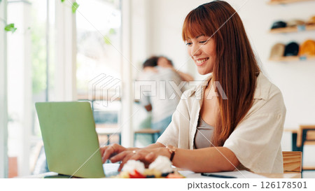 Coffee shop, remote work and woman on laptop in cafe for online project, research report and website, Professional, freelancer and person on computer in restaurant for breakfast, meal and break 126178501