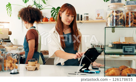 Waitress, woman and cash register in cafe for POS, track inventory or process payment at counter. Small business, cashier and electronic system for customer service, record transaction or hospitality 126178655