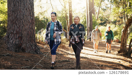 Mature, talking or friends on trail for hiking, outdoor adventure or journey in nature together. Travel, exercise and people in woods for holiday retirement, walking or trekking to explore terrain Mature, talking or friends on trail for hiking, outdoor adventure or journey in nature together. Travel, exercise and people in woods for holiday retirement, walking or trekking to explore terrain 126178691