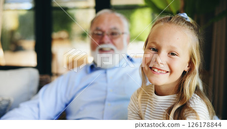 Portrait, home and grandfather with girl, smile and bonding together with generations, relax and love. Face, senior man and child with happiness, joy and rest with care, support and family with trust 126178844