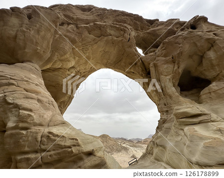 An arch formed by erosion and weathering in Timna Park in the Arava desert An arch formed by erosion and weathering in Timna Park in the Arava desert 126178899