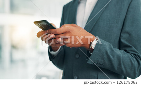 Business person, hands and typing with phone for communication, texting or online chatting at office. Closeup, employee or user with mobile smartphone for social media, research or app at workplace 126179062