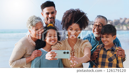 Happy, family and kids with selfie on beach for photography, vacation memory and social media post. Smile, grandparents and children for profile picture update, ocean travel and bonding together 126179120
