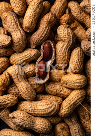 Pile of peanuts with one shell open 126179208
