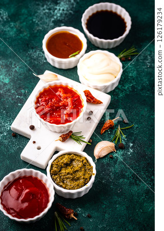 Set of different sauces. Ketchup, mustard, pesto 126179234