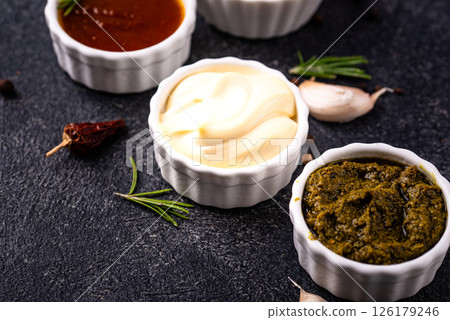Set of different sauces. Ketchup, mustard, pesto 126179246