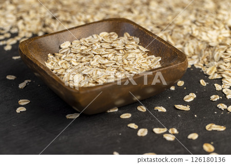 bowl and oatmeal for quick cooking of porridge, closeup 126180136